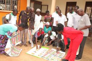 Some of the participants analyzing charts after the CSIA training in Kole District