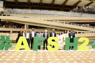 SAA management and country directors posing in front of the AFSH logo at the summit