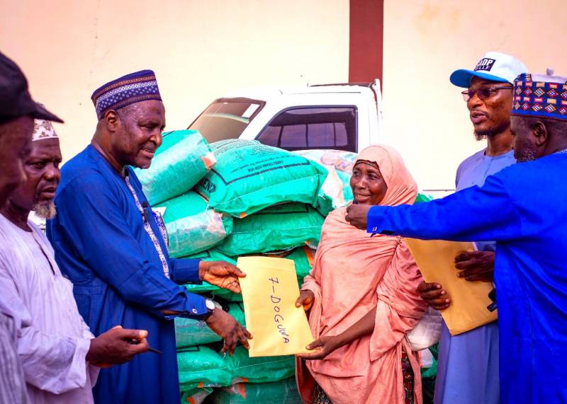 Representative of the Country Director, Prof Sani Miko presenting allocation papers to the lead EA for Doguwa LGA during the flag-off ceremony in Kano State