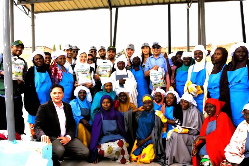 The IsDB, LLF delegation in a group photo with beneficiaries of the SAA/KSADP Rice Parboiling Enterprise Centre in Kura LGA, Kano state, Nigeria.