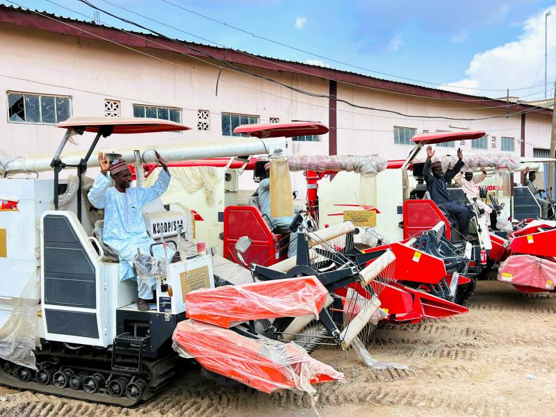 Beneficiaries salute SAA_KSADP after receiving combine harvesters during a recent mechanization equipment distribution exercise in Kano, Nigeria