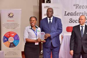 SAA’s Juliet Nakitende (M&E officer) receiving the award.
