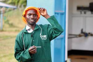 Kuzaima smiling to success as a youth agripreneur in Bugiri District turning agricultural services into a sustainable livelihood through the CCBF model.