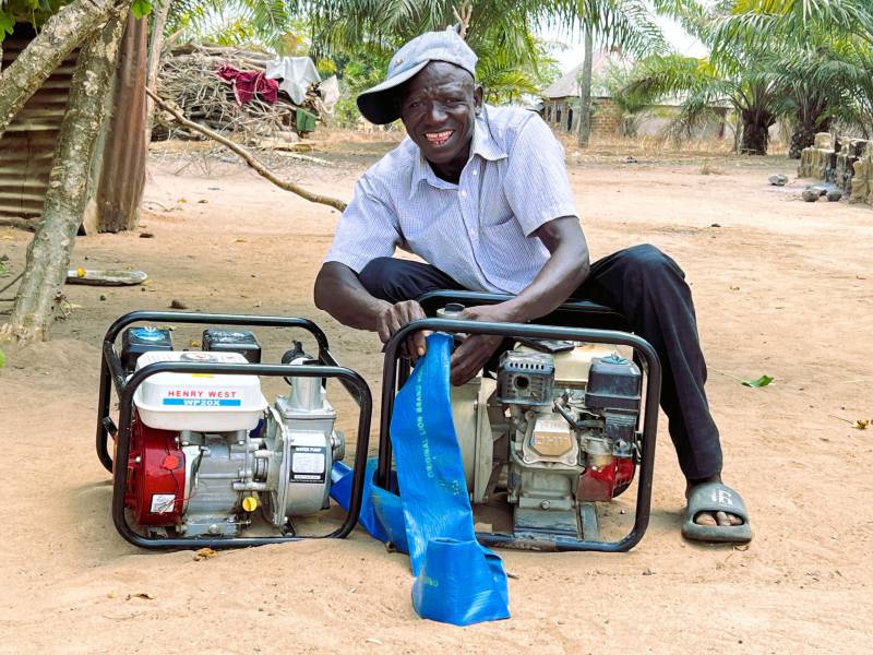 Mr Yusuf Ijeh displays his water pump machines acquired from sales of rice paddy under the PHRDG I project during a visit to his home by the PHRDG 1 team.