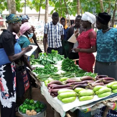A member of the farmers group sells her produce in Adjumani district