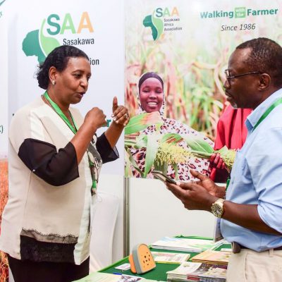 SAA staff explaining our work to a booth visitor